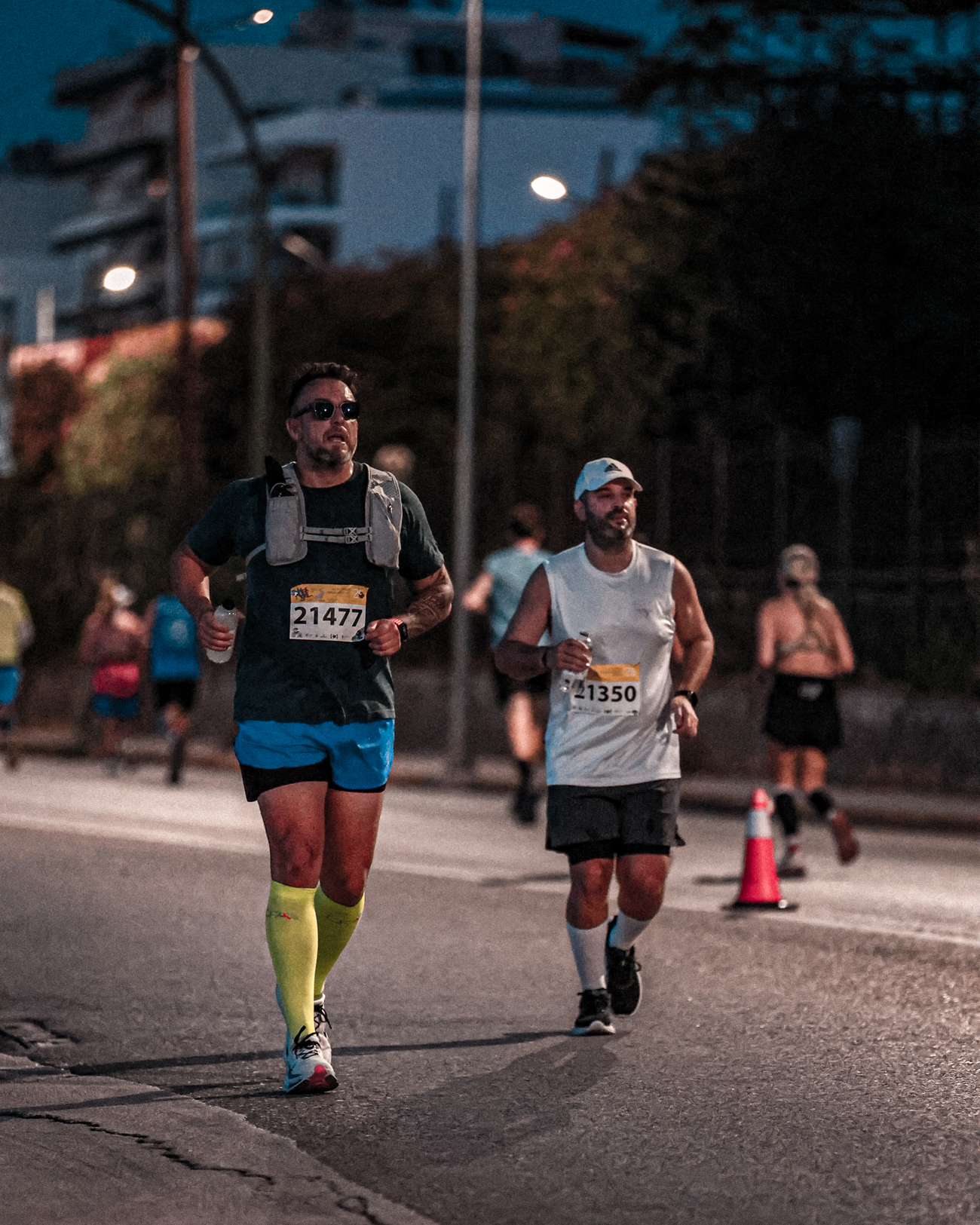 Paul and Iasonas running together at dusk during the Patras half marathon.