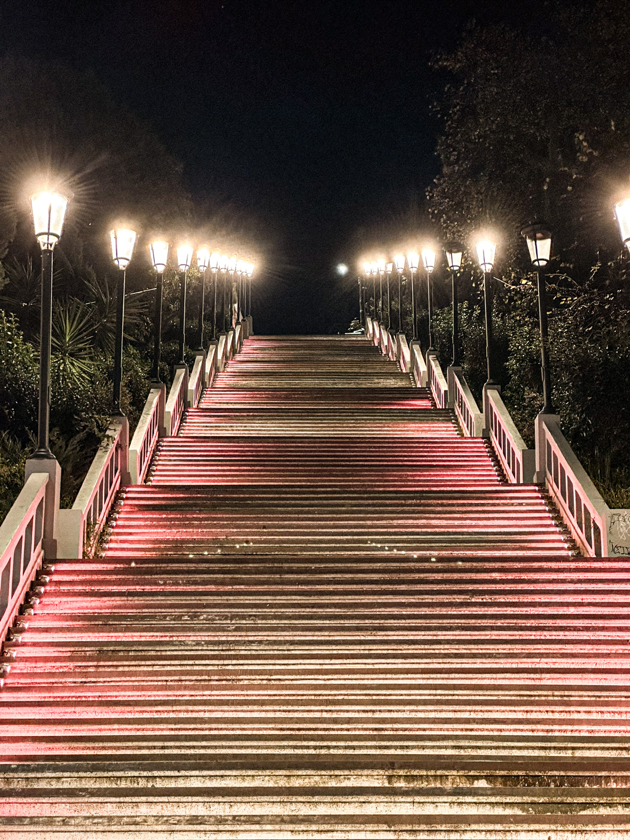 Agios Nikolaos steps in Patras at night, lined with lamps and pink lighting.